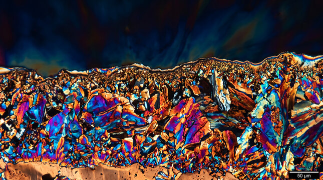 Vibrant Polarized Light Micrograph of Multicolored Crystalline Structures