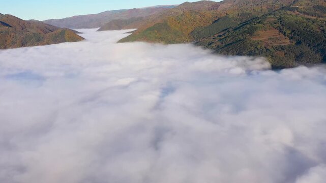 Aerial view of autumn morning fog and clouds in the valley