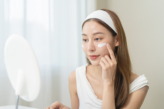 Routine skin care concept, Close-up woman applying cream on her face