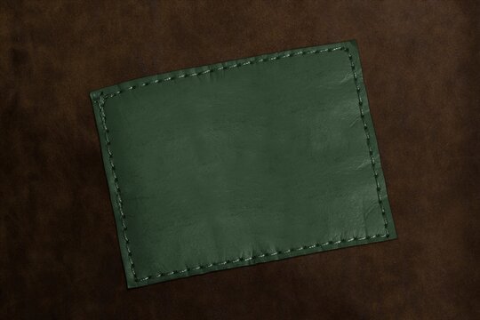 Green leather patch on dark textured background