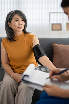 In Home Consultation. healthcare assessment for hypertension. Elderly person, caregiver and test for medical review, monitor or check .