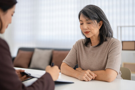 Financial advisors, real estate agents, insurance, retirement fund management concepts. Financial advisors present document plans to seniors planning for retirement.
