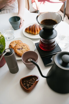Breakfast at Home with Freshly Brewed V60 Coffee, Warm Croissant and Homemade Cookies on a Bright Morning Table. vertical composition