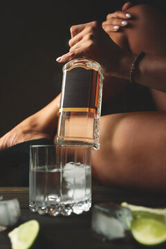 Beautiful Woman's Hand Holding Vodka Bottle