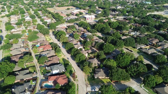 Paved street grids traverse leafy residential sectors near Cypress Waters corridors. Towering oak trees shade well tended suburban tracts across established Coppell, Texas