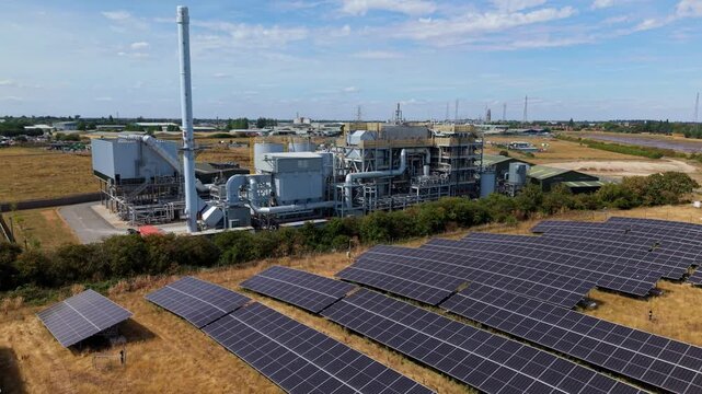Close up aerial view of industrial energy recovery facility and surrounding solar panel arrays Lincolnshire UK