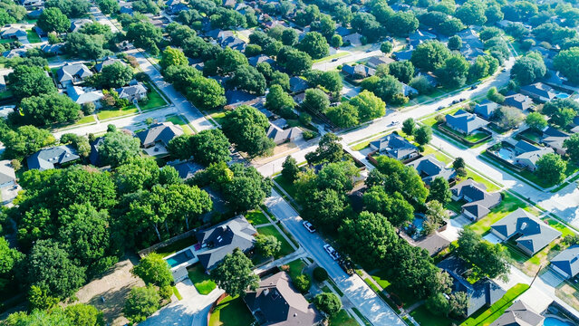 Intersecting roadways bisect lush residential parcels across quiet DFW Metroplex enclaves. Shaded emerald yards surround detached family dwellings throughout scenic Coppell, Texas