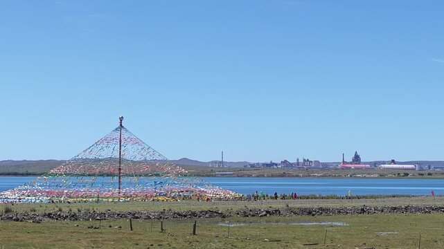 Scenic landscape of salt lake wetland and distant wind turbines in summer in Ulan Hada Volcano Geopark, Ulanqab, Inner Mongolia, China
