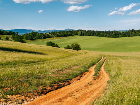 Rural road in the field. Muran, protected landscape in Slovakia
