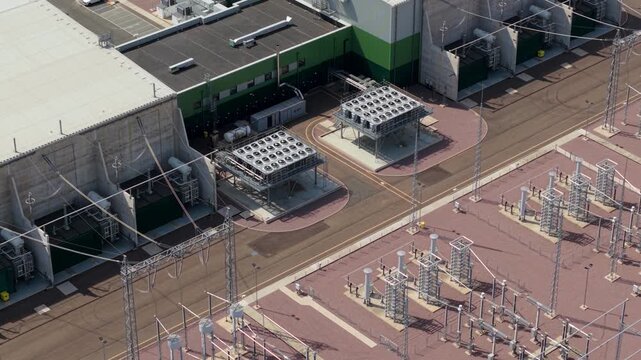 Close-up aerial view of massive rooftop cooling fan banks and HVDC converter halls at Viking Link interconnector station in Bicker Fen, Lincolnshire, UK