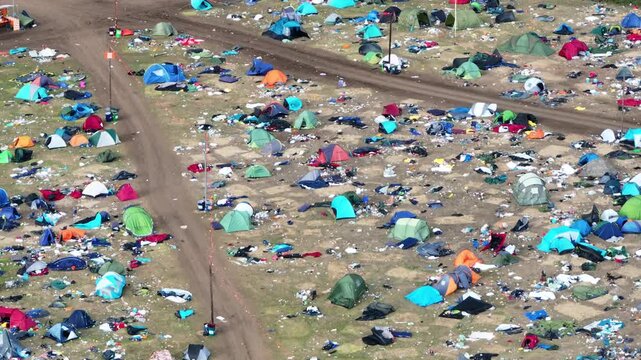Reading, United Kingdom - 31 August 2026: Aerial view of the Reading Festival campsite with numerous tents and scattered litter across the field.