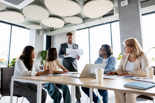 Diverse business team discussing project during office meeting