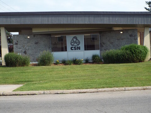 Gatineau, Quebec, Canada &ndash; July 02, 2026: A single-story office building with stone masonry features exterior branding for "CSN" on its windows and a manicured lawn at 408 Rue Main.