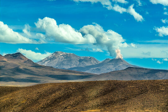 A  view of the active stratovolcano Sabancaya emitting a plume next to the dormant Ampato volcano in the Andes mountains of southern Peru in the dry season