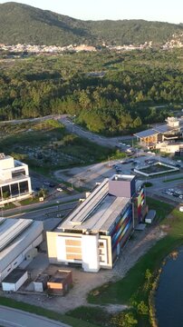 Artificial Lake Integrated with Modern Technology Buildings and Green Infrastructure in Florian&oacute;polis, Brazil. Establishing Shot. Aerial View.