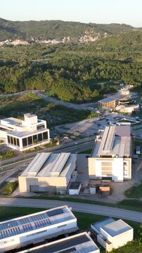 Artificial Lake Integrated with Modern Technology Buildings and Green Infrastructure in Florian&oacute;polis, Brazil. Establishing Shot. Aerial View.