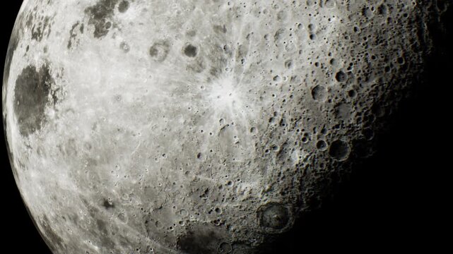The moon is visible in the night sky with a focus on its surface. Craters and texture can be seen clearly under the light. This view shows the natural features of the moon.
