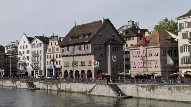 Zurich, Zurich, Switzerland - 22 August 2026: View of historic guild houses along the Limmat river with traditional architecture and stone embankments.