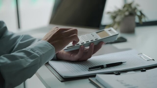 Accountant calculating numbers in office with documents for valuation accuracy