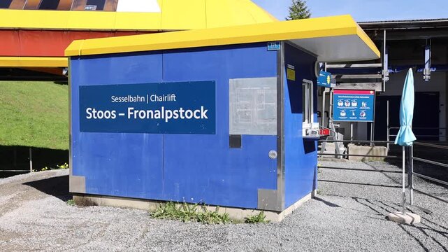 Morschach, Schwyz, Switzerland - 22 August 2026: View of the Stoos-Fronalpstock chairlift station building with its blue walls and yellow roof under a clear sky.