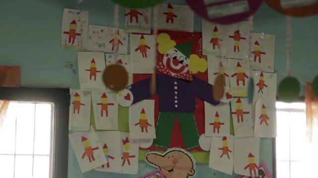 Children Drawings And Clown Crafts Displayed On Kindergarten Wall