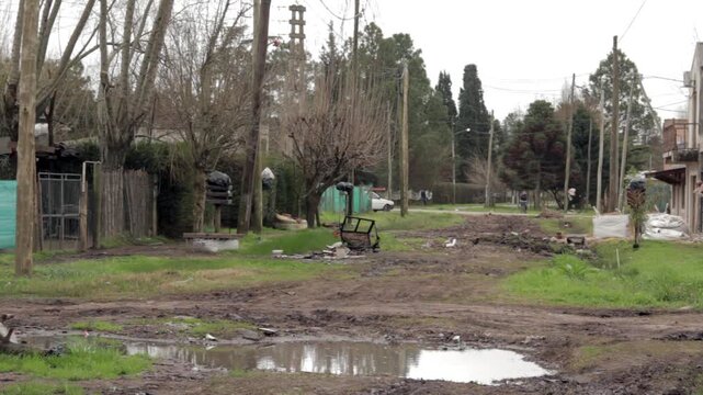 Unpaved Dirt Road With Puddles In Poor Suburban Neighborhood Of Moron Buenos Aires Argentina