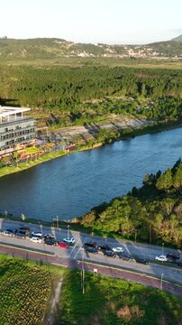 Artificial Lake Integrated with Sustainable Infrastructure, Modern Buildings and Preserved Green Landscape in Florian&oacute;polis, Brazil. Establishing Shot. Aerial View.