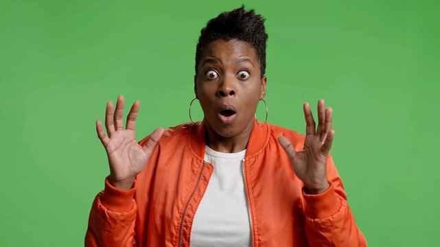 Surprised Black Woman in Orange Bomber Jacket on Green Screen Chroma Key