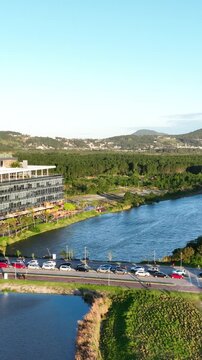 Artificial Lake Integrated with Sustainable Infrastructure, Modern Buildings and Preserved Green Landscape in Florian&oacute;polis, Brazil. Establishing Shot. Aerial View.