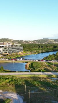 Artificial Lake Integrated with Sustainable Infrastructure, Modern Buildings and Preserved Green Landscape in Florian&oacute;polis, Brazil. Establishing Shot. Aerial View.