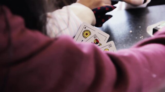 Young Woman Holding Spanish Playing Cards In Hand Indoors - 4K