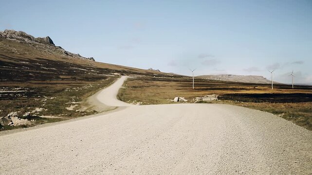 Wide View Of Dirt Road And Wind Turbines In Open Countryside - 4K