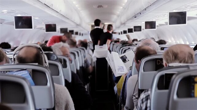 Interior View Of Commercial Airplane Cabin With Passengers During Flight - 4K