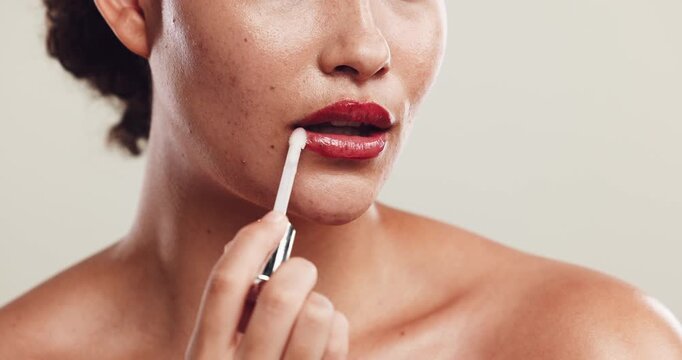 Woman, beauty and mouth in studio with lip gloss, confidence and color cosmetics for style. Lipstick, female person and kiss on white background with makeup, closeup and hydration treatment for care