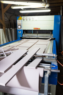 Grinding of wooden furniture panels on a machine. Furniture production concept