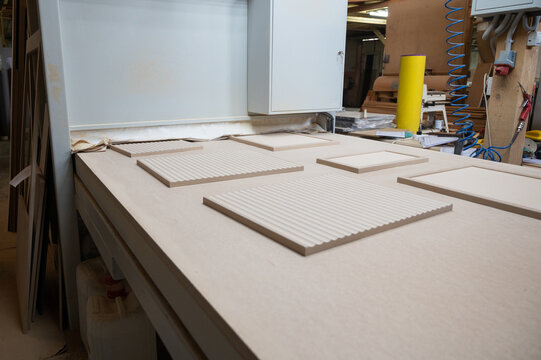 Grinding of wooden furniture panels on a machine. Furniture production concept
