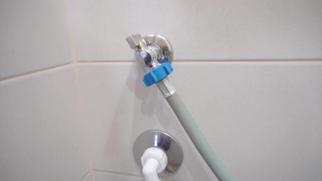 Video of the supply water pipe and drain for the washing machine.A close-up of the water supply and drain pipes for a washing machine, a household engineering system, and a home infrastructure concept