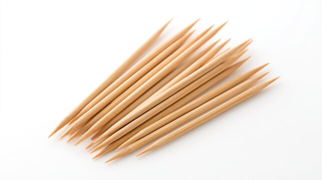 Group of pointed wooden toothpicks scattered on white background