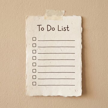 Blank To Do List on textured paper taped to a wall for task management and planning