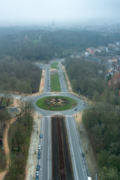 View of a roundabout surrounded by trees and urban roads in Bruxelles, Bruxelles, Belgium.