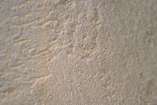 Concrete wall texture with rough surface details creating an abstract background, showing natural imperfections and a weathered grunge effect for architectural design