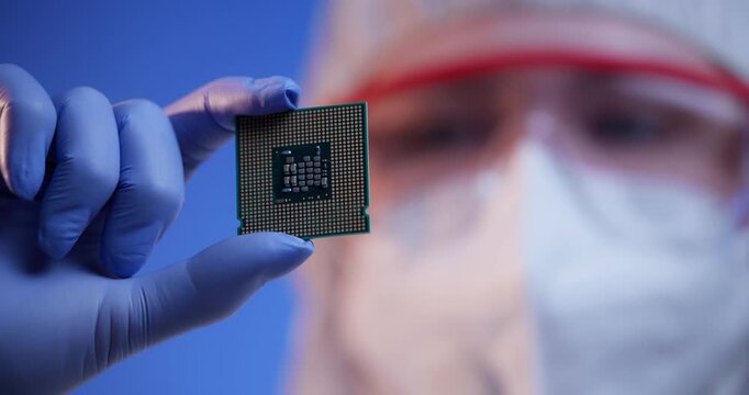 Engineer presenting micro chip for inspection in laboratory cleanroom, control quality of semiconductor on artificial intelligence factory.