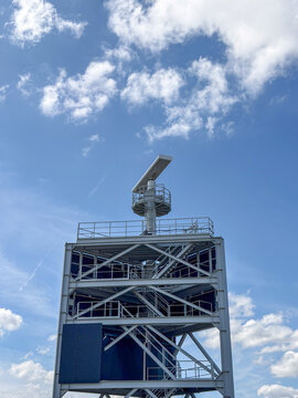 Airport or Port Radar Tower with Rotating Antenna Against Blue Sky &mdash; Antwerp, Belgium