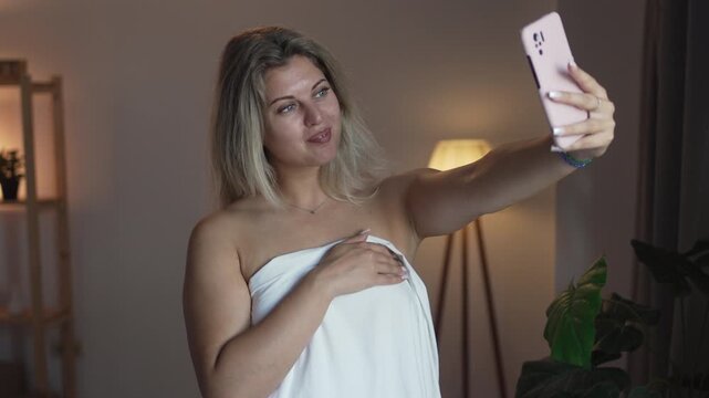 A girl in underwear flirts on an online video connection on a laptop. Woman working as a web cam model