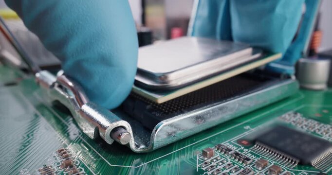 Probe view of technician installing cpu on motherboard inside computer case with gloved hand moving over components services in data center.