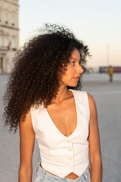 Woman With Curly Hair on Street at Sunset in City. Lisboa, Portugal