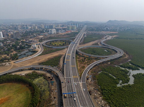 Aerial view of the Atal Bihari Vajpayee Sewri-Nhava Sheva Atal Setu highway interchange with modern road infrastructure and surrounding mangroves in Mumbai, Maharashtra, India.