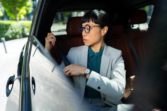 Businesswoman Fastening Seatbelt