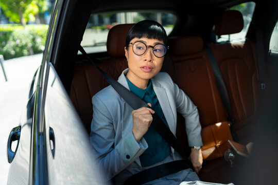 Businesswoman Fastening Seatbelt