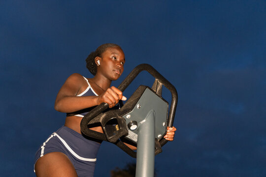 Young Woman Exercises Outdoors During Evening Hours. Copy space